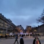 Police vans and a CRS cordon at Place de la Nation in Paris during a 2023 demonstration
